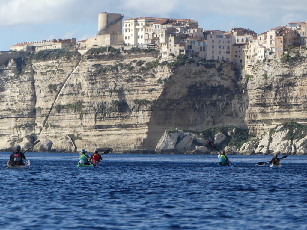 seakayaking towards bonifacio city in corsica. Un groupe en kayak de mer en direction de bonifacio en corse