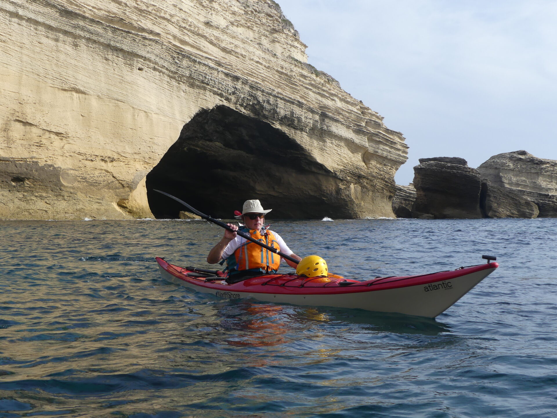 jim in his seakayak fiberglass from north shore in front of 'la pointe de saint antoine'. jim dans son kayak de mer 'atlantic' devant la pointe saint azntoine à bonifacio