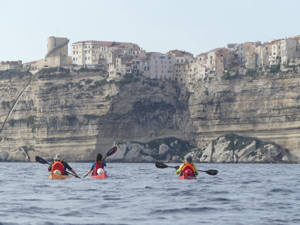 seakayaking towards bonifacio city in corsica. Un groupe en kayak de mer en direction de bonifacio en corse